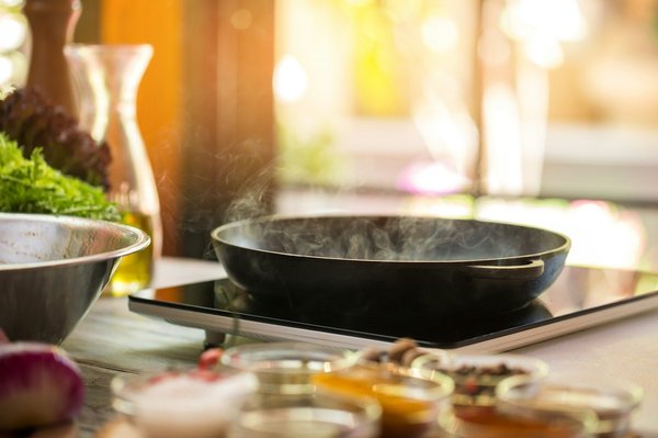 How can you design a kitchen to facilitate easy recycling and composting?